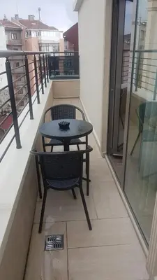 a table and chair on the balcony of a building at Regard Hotel in Istanbul