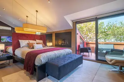 a bedroom with a large bed and a balcony at Deger 16 Residences in Istanbul