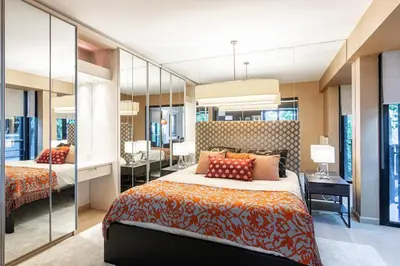 a bedroom with two beds and a desk and a mirror at Deger 16 Residences in Istanbul