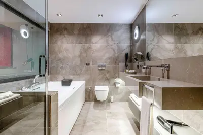 a bathroom with a tub and a toilet and a sink at AHC Taksim Hotel-Special Class in Istanbul