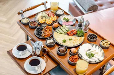 a table full of breakfast foods and cups of coffee at AHC Taksim Hotel-Special Class in Istanbul