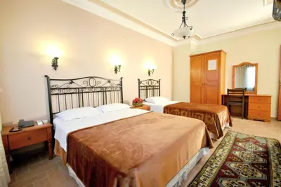 a hotel room with two beds and a dresser at Side Hotel in Istanbul