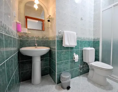 a bathroom with a sink and a toilet and a mirror at Side Hotel in Istanbul