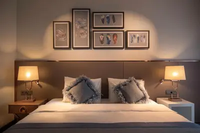 a bedroom with a bed with three pictures on the wall at Lionel Hotel Istanbul in Istanbul