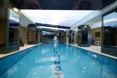 a large swimming pool in a building at Ilkbal Deluxe Hotel &Spa Istanbul in Istanbul