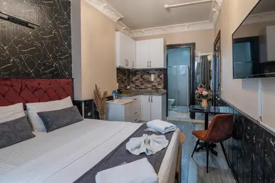 a small bedroom with a bed and a kitchen at Nest HOTEL Sisli in Istanbul