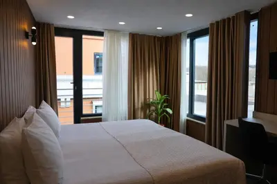 a hotel room with a bed and a balcony at Hotel Evsen in Istanbul