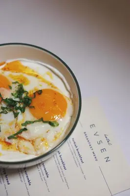a bowl of eggs on top of a book at Hotel Evsen in Istanbul