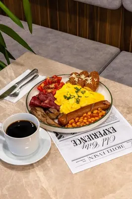 a plate of breakfast food on a table with a cup of coffee at Hotel Evsen in Istanbul