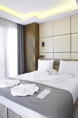 a large bed with white sheets and towels on it at AMARA OLD CITY HOTEL & Spa in Istanbul