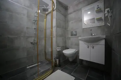 a bathroom with a shower and a sink and a toilet at Hotel Aksaray istanbul in Istanbul