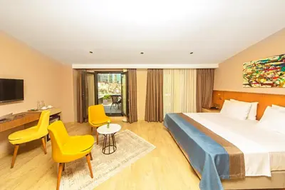 a hotel room with a bed and a desk and chairs at Redmont Hotel Nisantasi in Istanbul