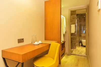 a bathroom with a wooden desk and a yellow chair at Redmont Hotel Nisantasi in Istanbul