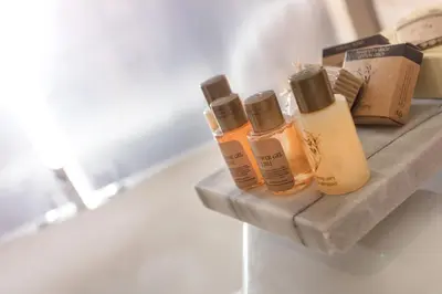 a shelf with four bottles of hair products on it at İstanbul Medikal Termal in Tuzla