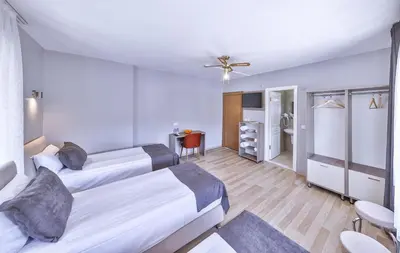 a hotel room with two beds and a bathroom at Palmada Hotel in Sakarya