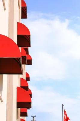 a building with red balconies on the side of it at Palmada Hotel in Sakarya