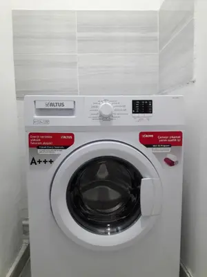 a white washing machine in a room at Golden Life Apart Hotel in Istanbul