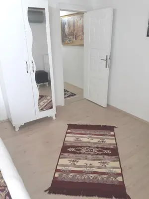 a hallway with two white doors and a rug at Golden Life Apart Hotel in Istanbul