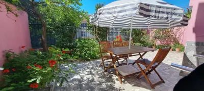 a table and chairs under an umbrella on a patio at Golden Life Apart Hotel in Istanbul