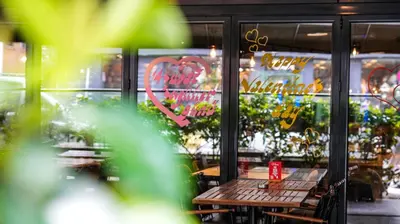 a window of a restaurant with a wooden table in front at Milord Hotel in Istanbul