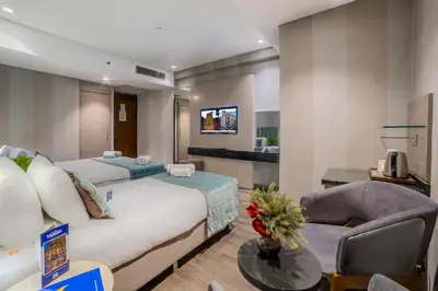a hotel room with a bed and a living room at The Tango Hotel İstanbul in Istanbul