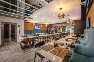 a restaurant with tables and chairs in a room at The Tango Hotel İstanbul in Istanbul