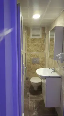 a bathroom with a white toilet and a sink at Göznur Otel in Bandırma