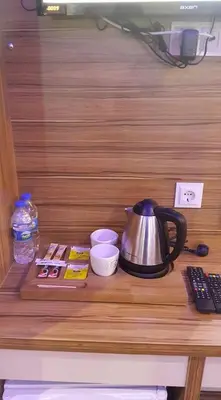 a tea kettle on top of a wooden shelf at Göznur Otel in Bandırma