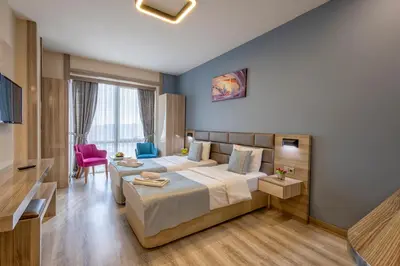 a hotel room with a bed and a couch at My House N5 Suites Hotel in Esenyurt
