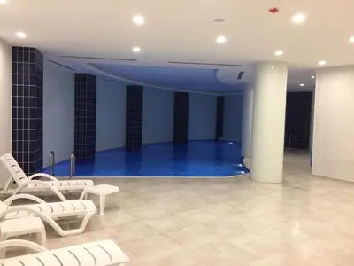 a room with white chairs and a blue stage at My House N5 Suites Hotel in Esenyurt