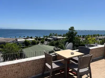 a table and chairs on a balcony with a view of the ocean at Sultanahmet inn Hotel in Istanbul