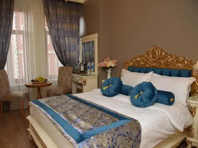 a bedroom with a bed with blue pillows on it at İstasyon Hotel in Istanbul