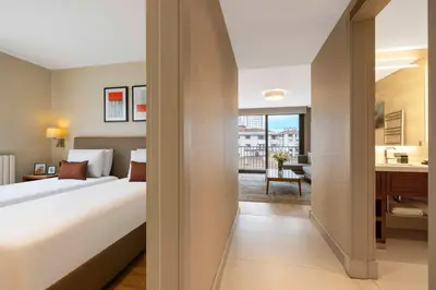 a hotel room with a large bed and a kitchen at Tzl Suites Hotel Nişantaşı in Istanbul