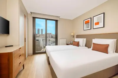 a hotel room with two beds and a window at Tzl Suites Hotel Nişantaşı in Istanbul