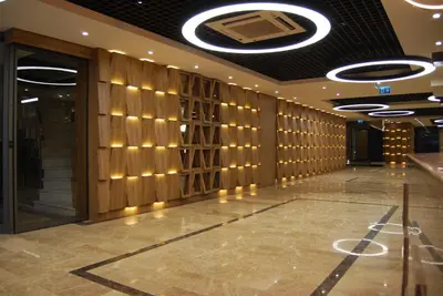 a lobby with a wall of wood panels and a ceiling at The City Suites in Istanbul