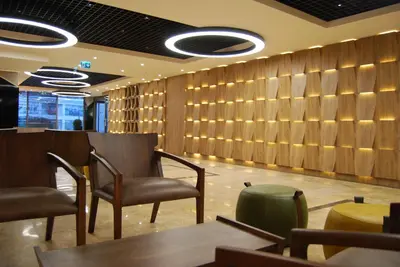 a restaurant with wooden walls and chairs and tables at The City Suites in Istanbul