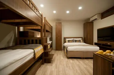 a hotel room with two beds and a flat screen tv at Ferman Konak Hotel-Special Category in Istanbul