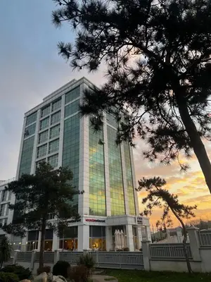 a large glass building with a tree in front of it at Zin D Home Dudullu Otel in Istanbul