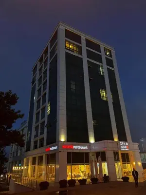 a tall building with lights in the night at Zin D Home Dudullu Otel in Istanbul