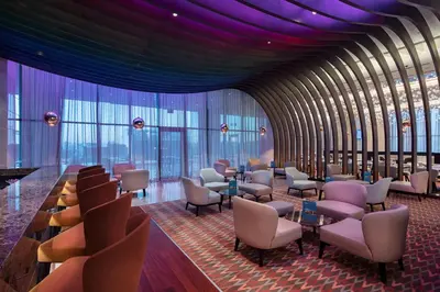 a waiting room with chairs and tables and purple ceilings at Doubletree by Hilton Istanbul Umraniye in Istanbul