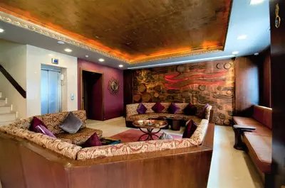a living room with a couch and a stone wall at Ferman Hotel Old City -Special Category in Istanbul