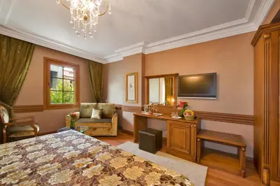 a bedroom with a bed and a desk and a chair at Ferman Hotel Old City -Special Category in Istanbul