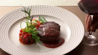 a white plate with a piece of food on a table at Endglory Hotel in Corlu