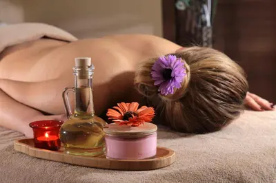 a woman laying on a bed with a bottle of oil at Bricks Hotel İstanbul in Istanbul