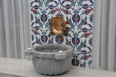 a bathroom with a tub in front of a wall at Bricks Hotel İstanbul in Istanbul