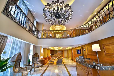 a large lobby with a chandelier and a living room at Adelmar Hotel Istanbul Sisli in Istanbul
