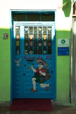 a blue door with a woman painted on it at Green Life Apart Hotel in Istanbul