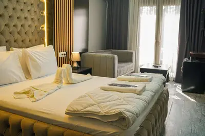a bedroom with a large bed with a large headboard at Ömer Agah Istanbul Hotel Bayrampasa in Istanbul