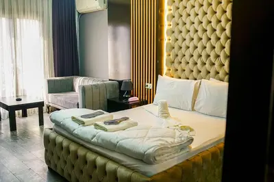 a bedroom with a large bed with a large headboard at Ömer Agah Istanbul Hotel Bayrampasa in Istanbul
