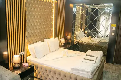a bedroom with a white bed with a mirror at Ömer Agah Istanbul Hotel Bayrampasa in Istanbul